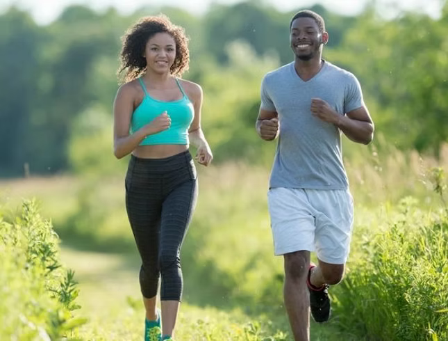 Woman running outdoors on a sunny path